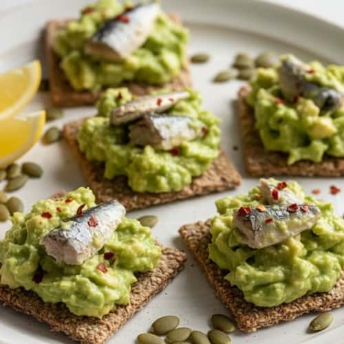 2. Sardine and Avocado Smash on Seed Crackers